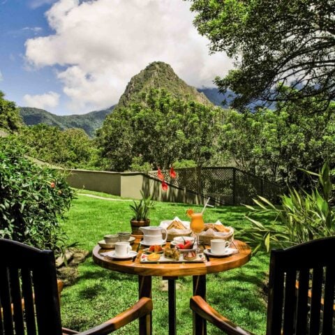 A meal for two set up outdoors after a hiking trip to Machu Picchu's Sanctuary Lodge